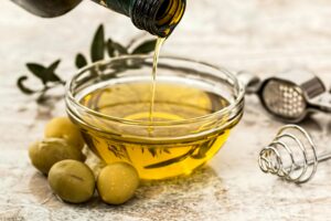 olive oil being poured into a bowl